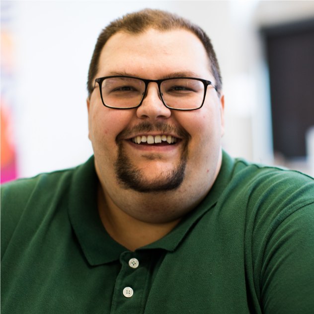 Smiling man in a green polo shirt