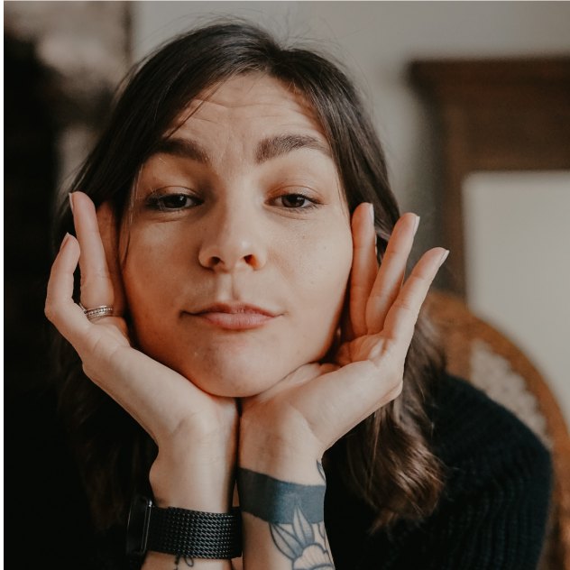 Woman with her hands to her face, thinking